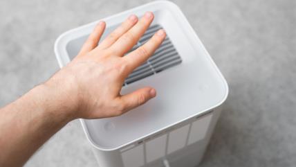 Muškarac uključuje prečišćivač vazduha