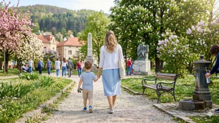 Mama sa detetom šeta kroz park