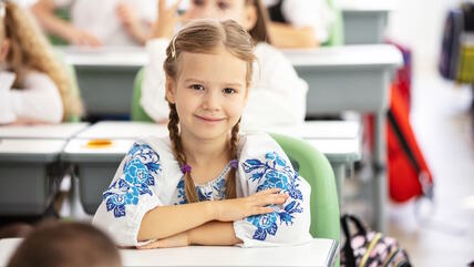 Devojčica sedi u školskoj klupi